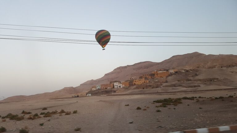 Hot air balloon above the desert edge and hills near Luxor